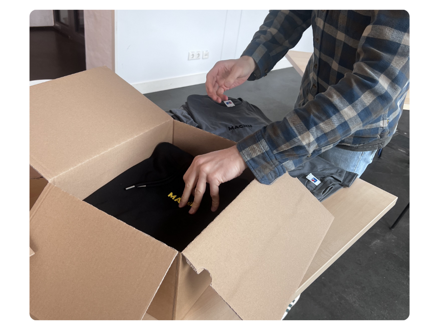 person unboxing a custom t-shirt order to show turnaround time when using spreadshop