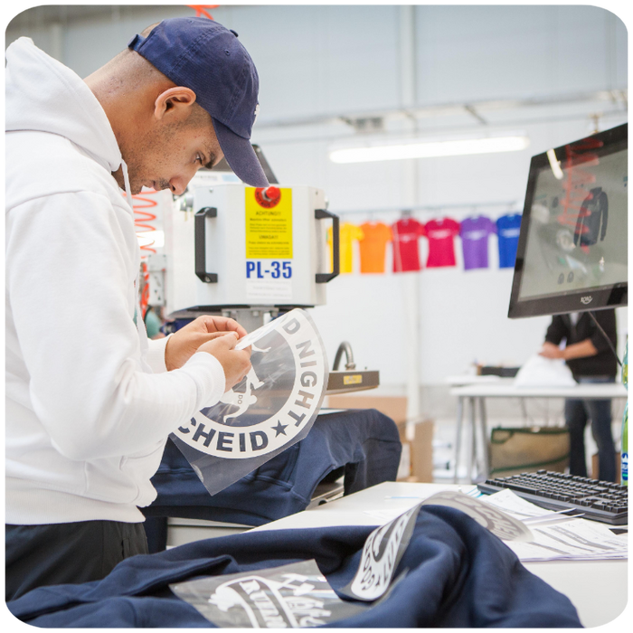 production employee in las vegas making a print for an apparel item for a custom order