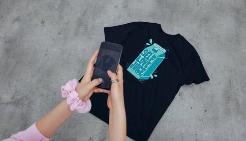 person taking a photo of a t-shirt