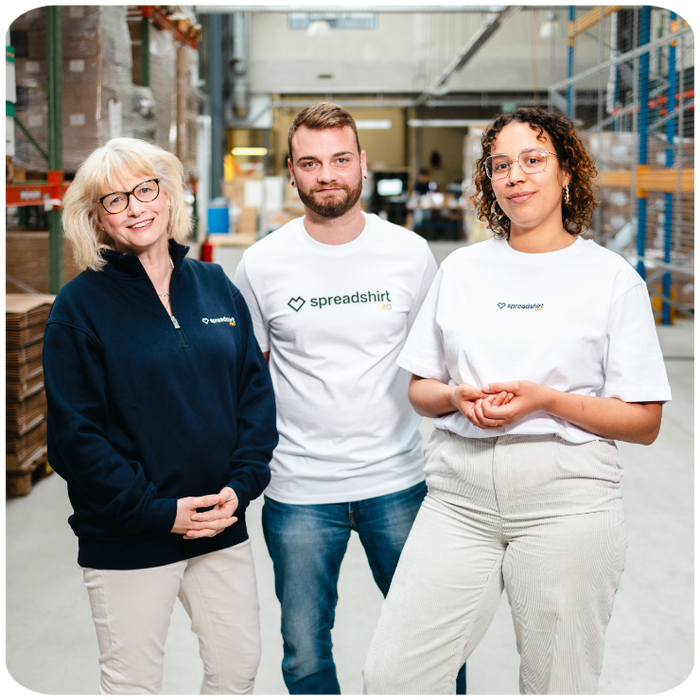 production and marketing employees standing on the production floor of the printing facility