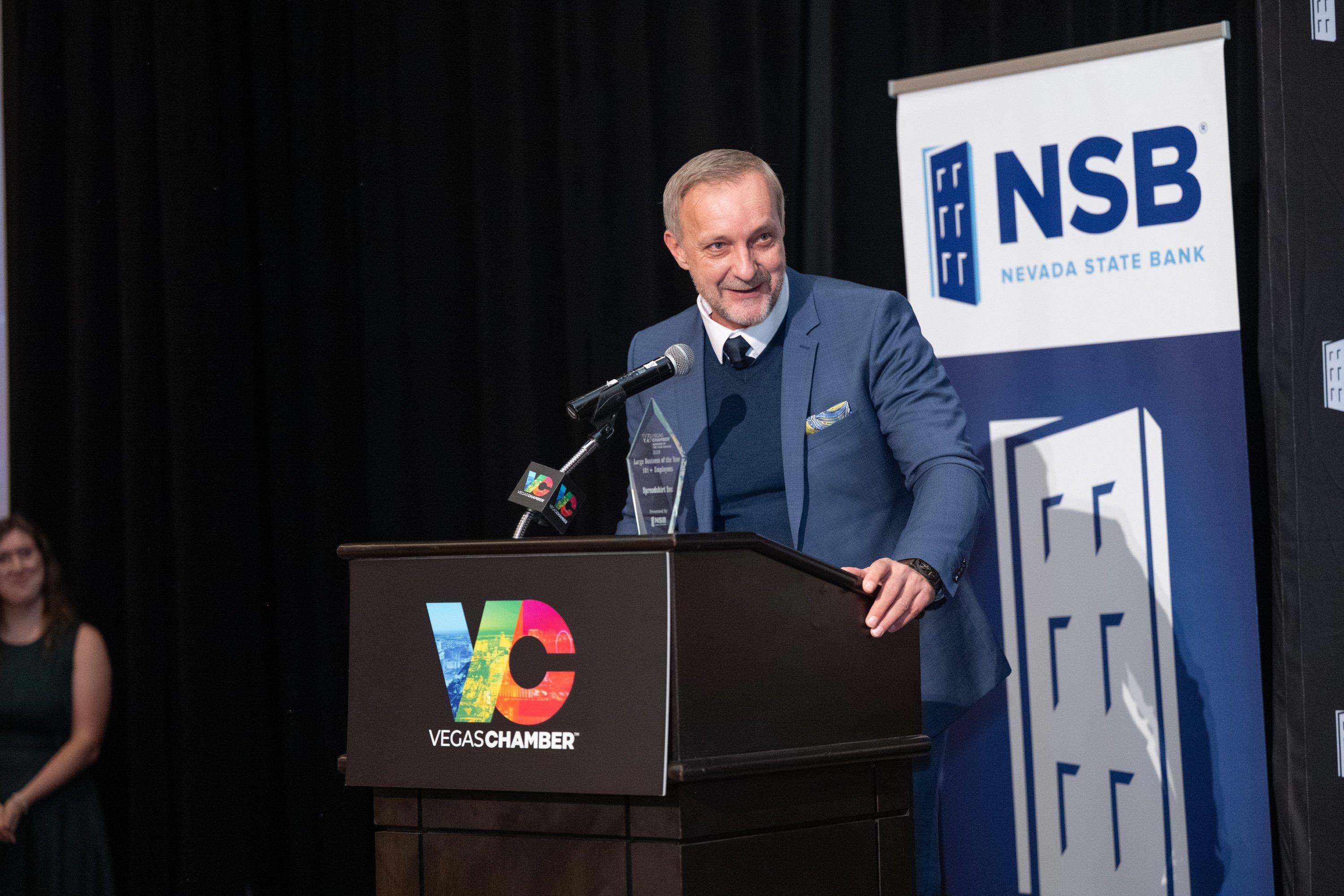 president dennis doerfl accepts business award