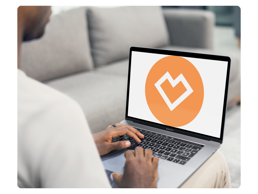 seller on laptop with an orange heart graphic to illustrate spreadshop earnings
