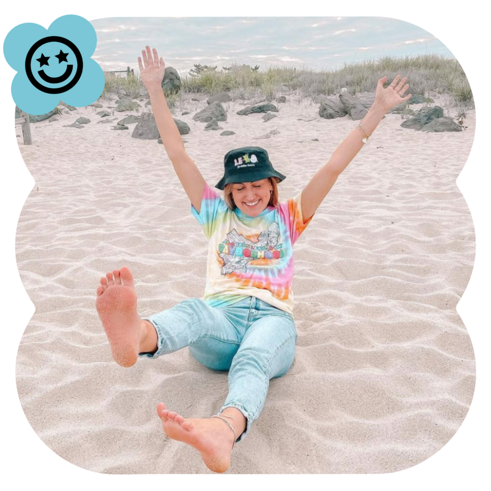 image of tiktok creator on the beach wearing products they made using spreadshop