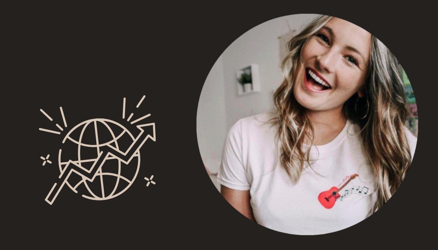 girl wearing a white t-shirt with a pink guitar graphic as a moment merch example