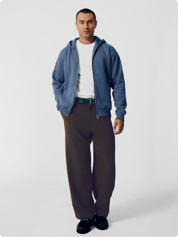 male model wearing unzipped blue hoodie and white t-shirt