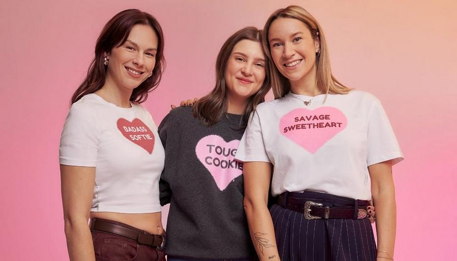 Three people wearing Valentine’s Day t-shirts with heart graphic designs