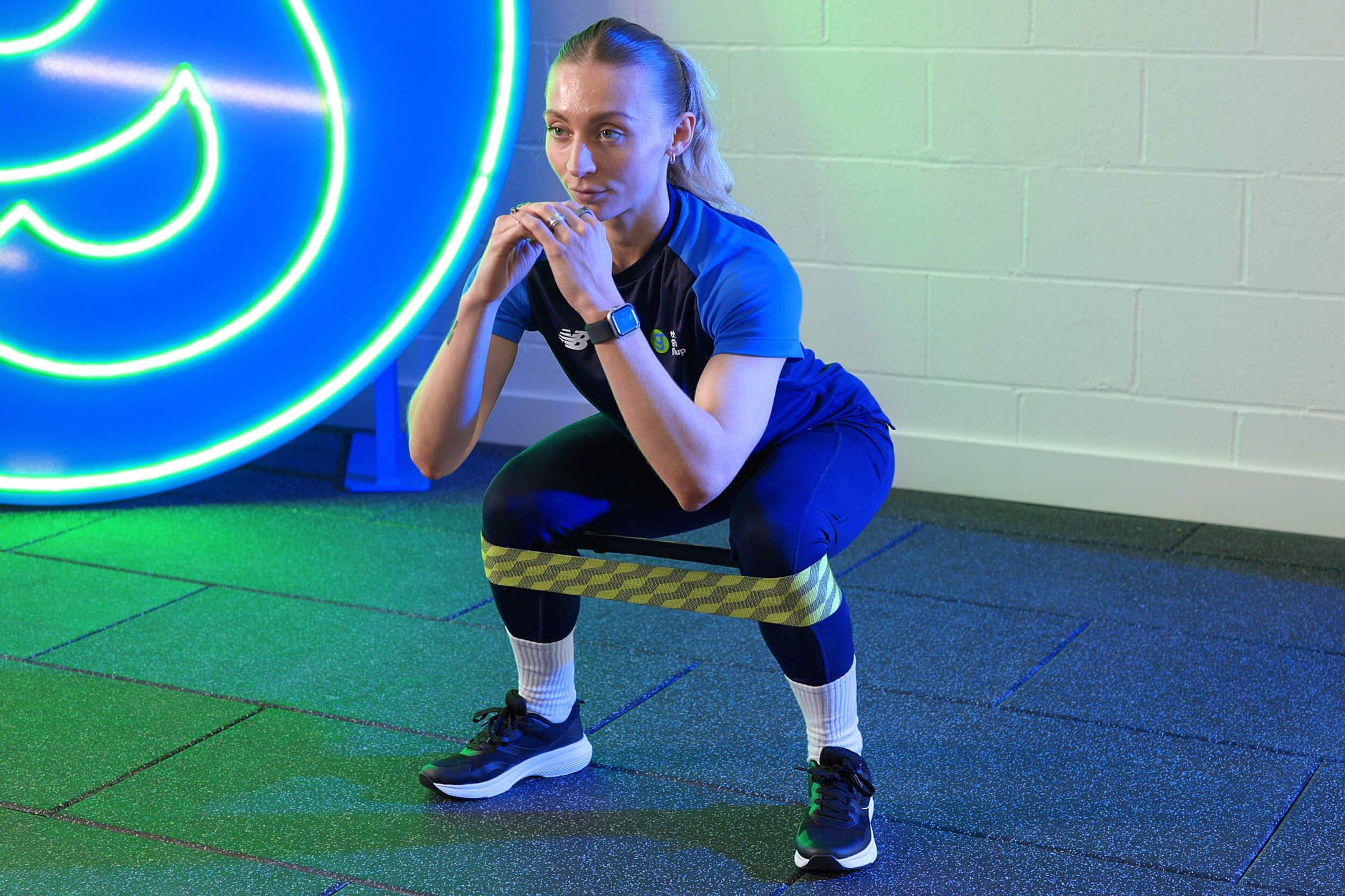 Member of Gym staff demonstrating an exercise.