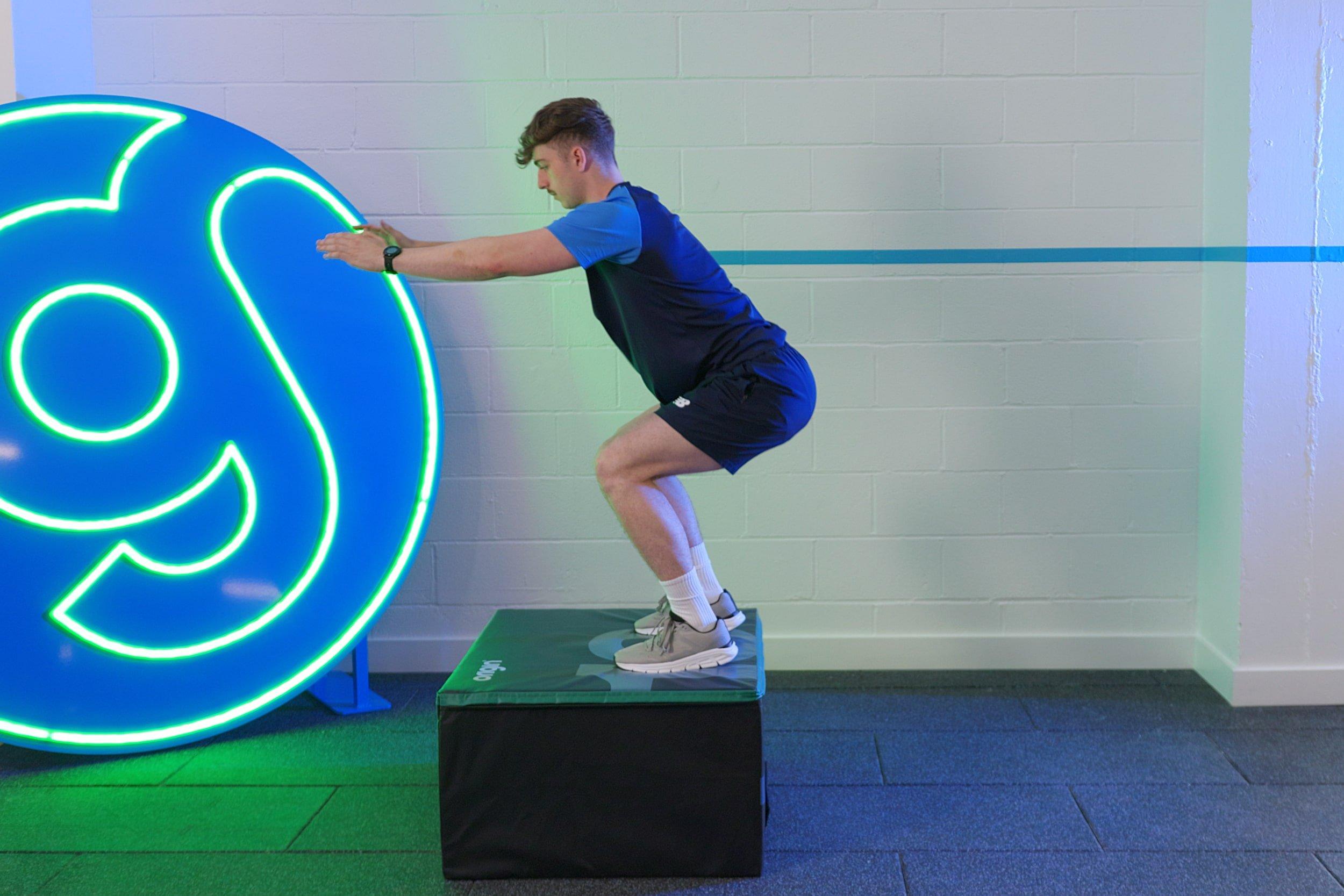 PT demonstrating how to do box jumps. 