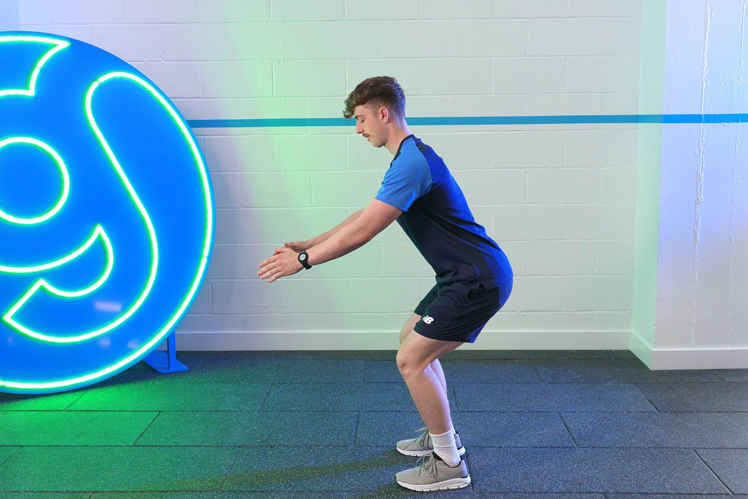 PT demonstrating how to do burpees.