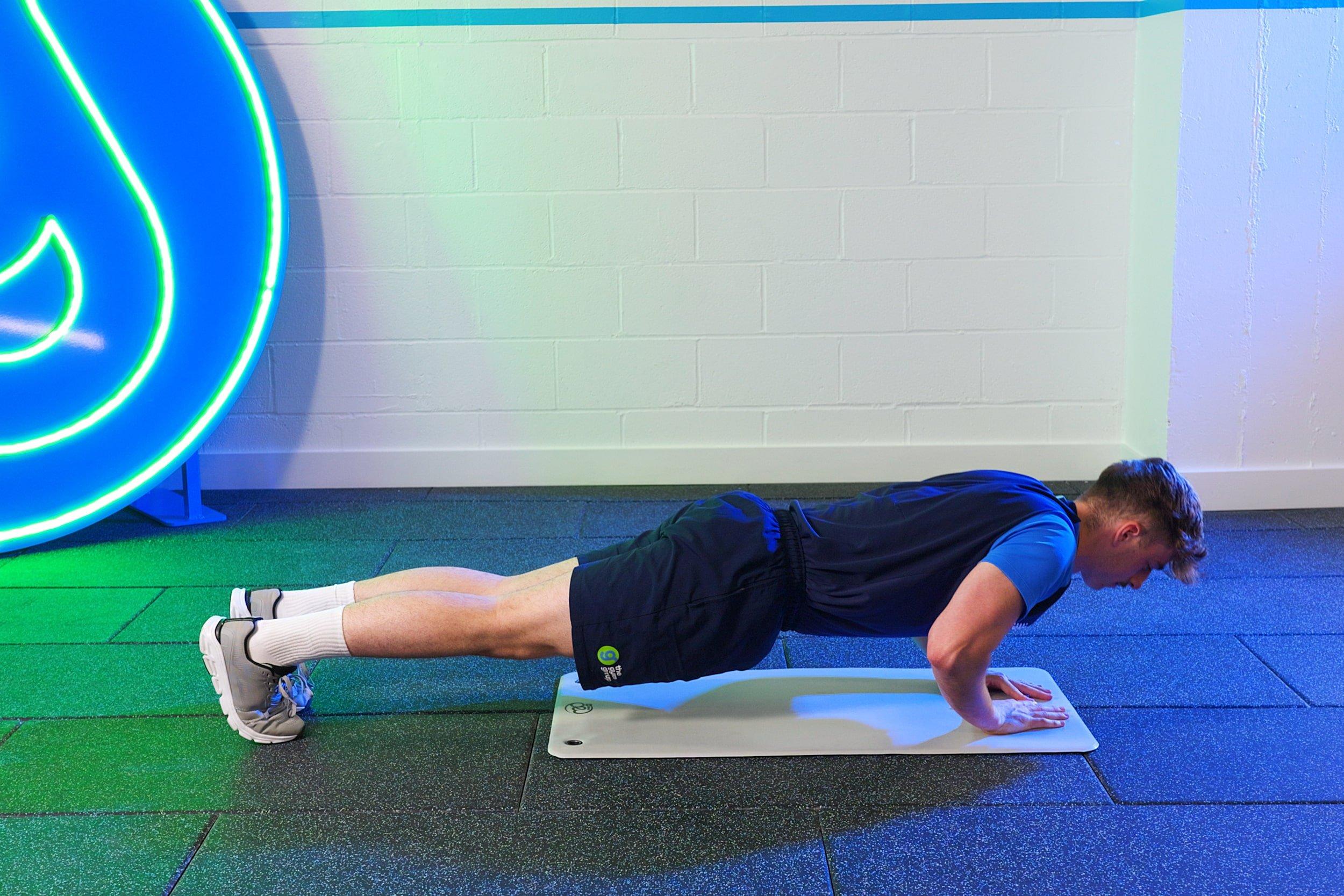 The Gym Group trainer demonstrating a diamond push-up.