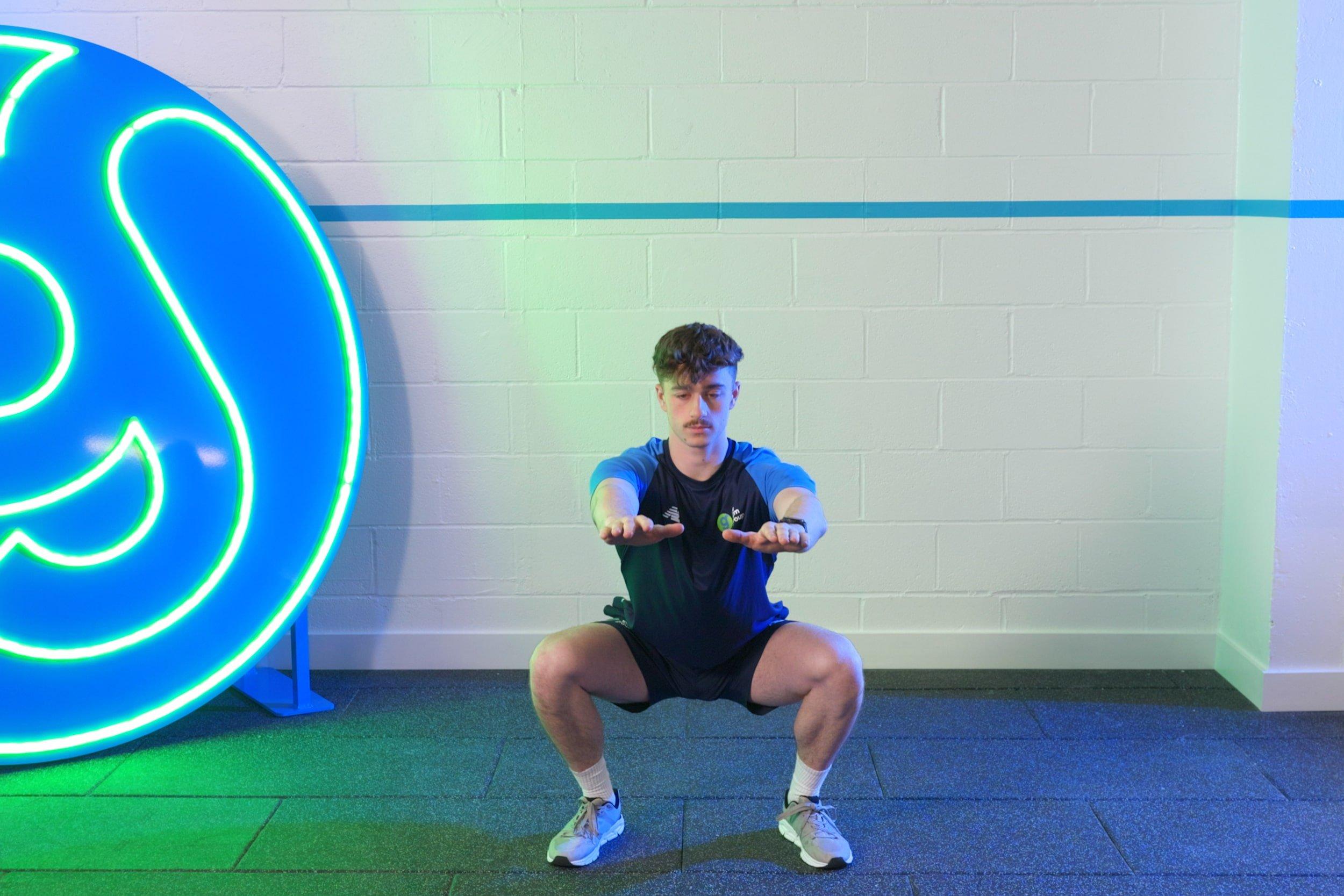 Gym member doing squats