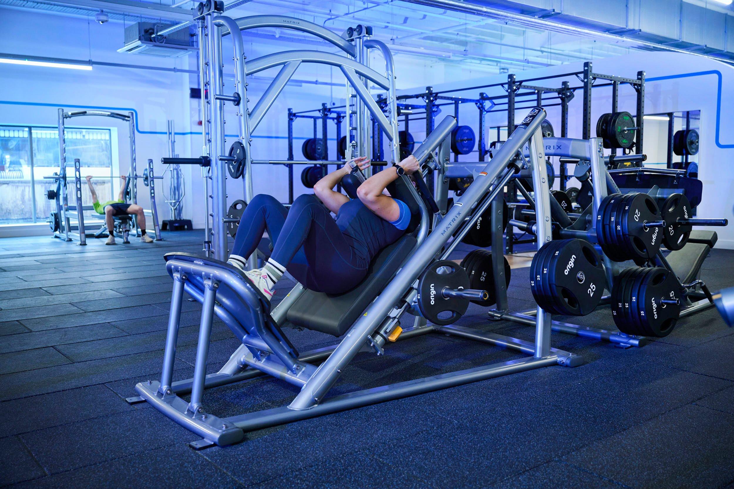 Gym member using the hack squat machine.