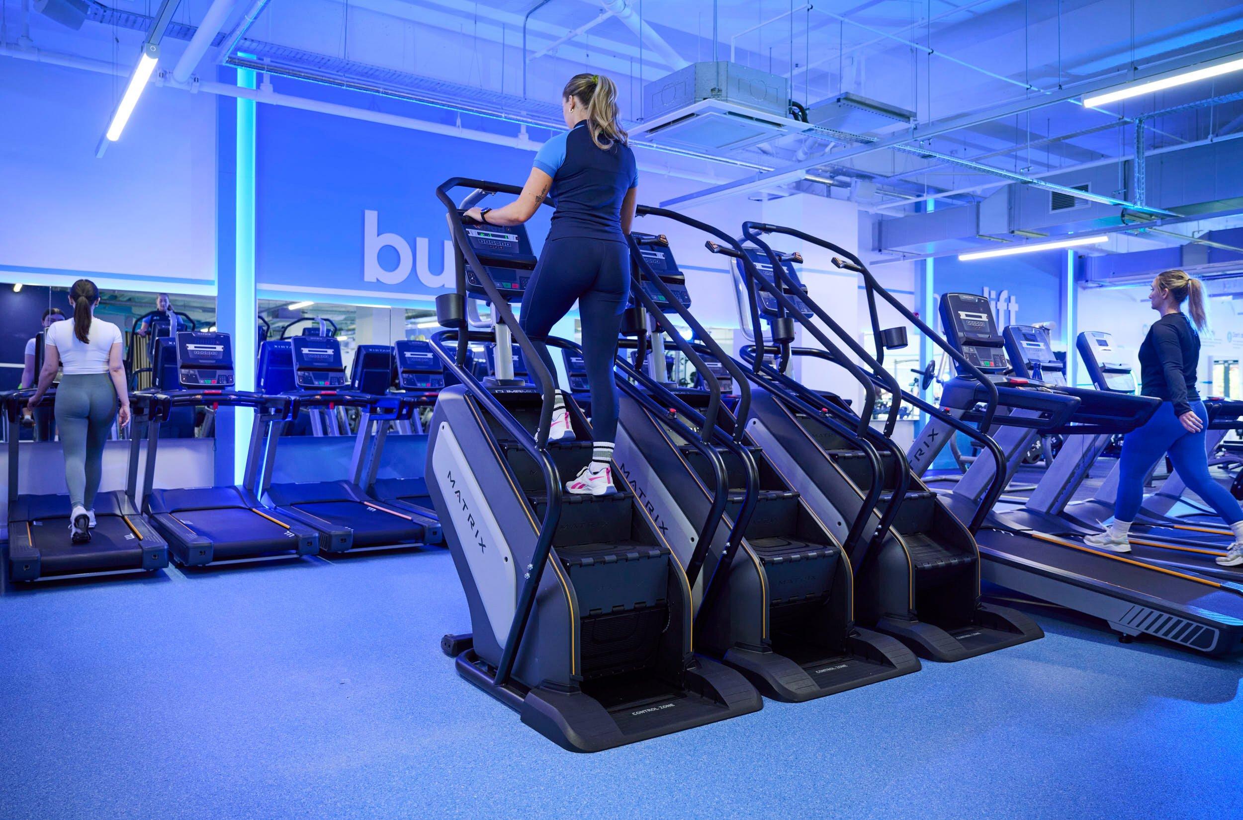 The Gym Group trainer demonstrating how to use a StairMaster.