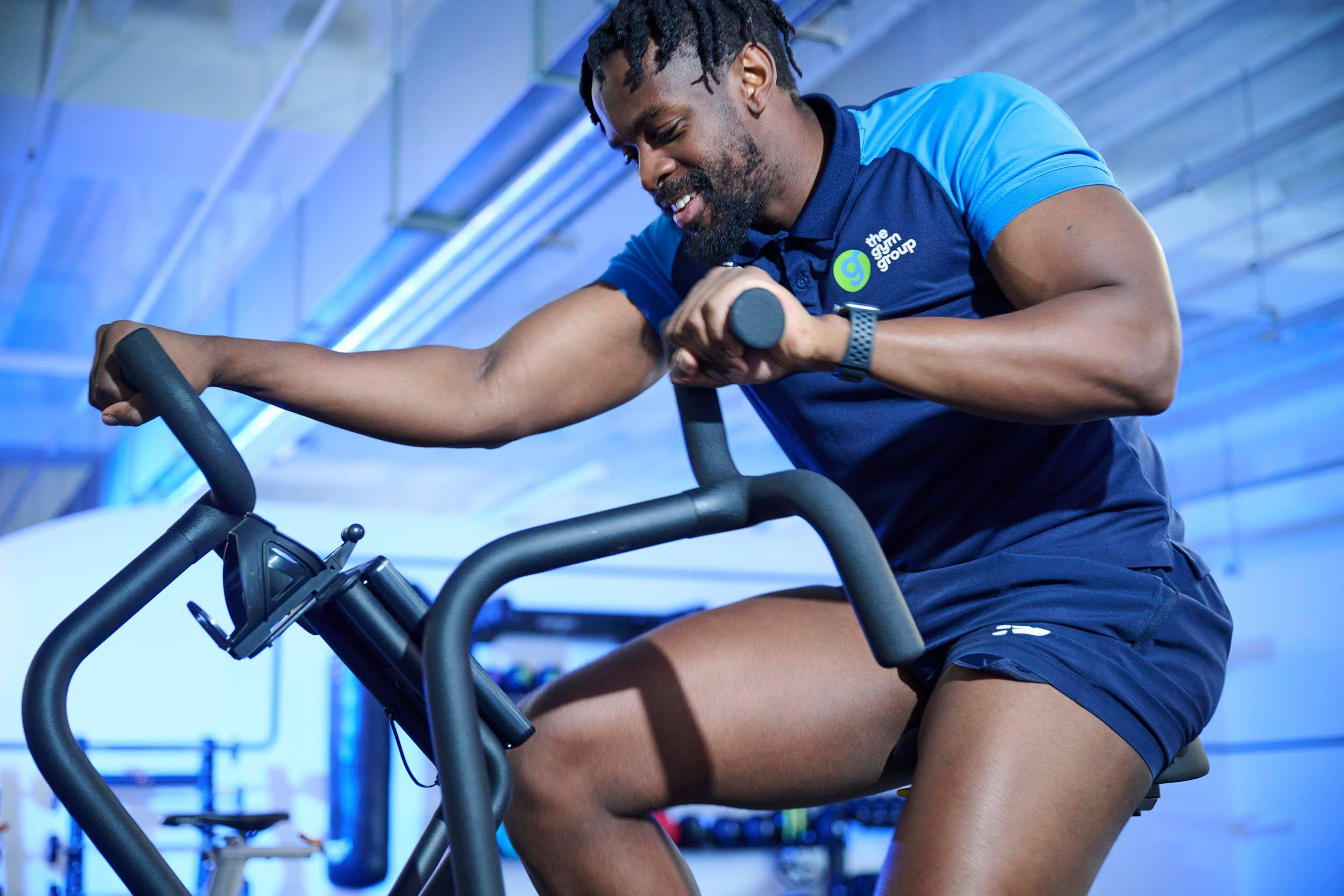 Gym member using the air bike