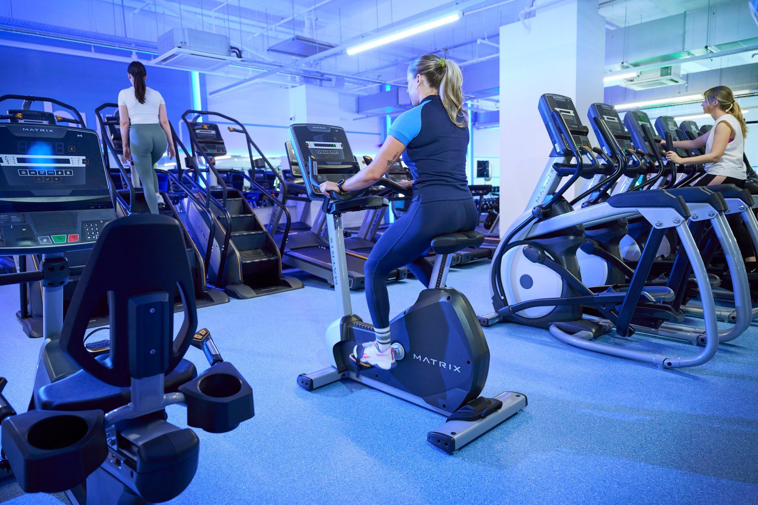 Gym member on the upright bike