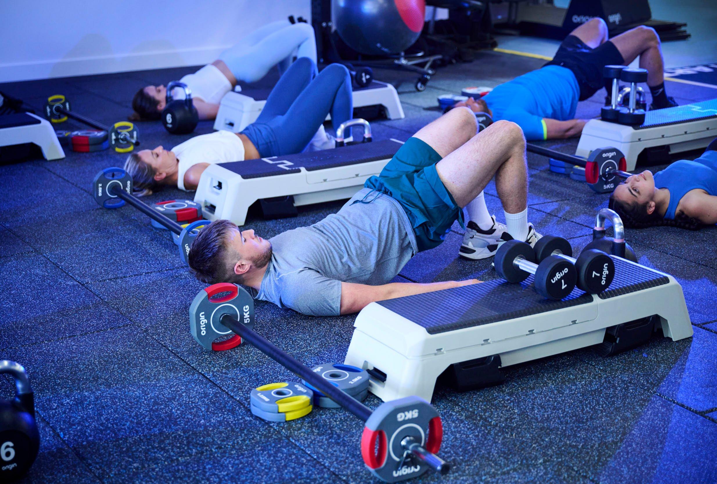 Members doing squats at a lower body class