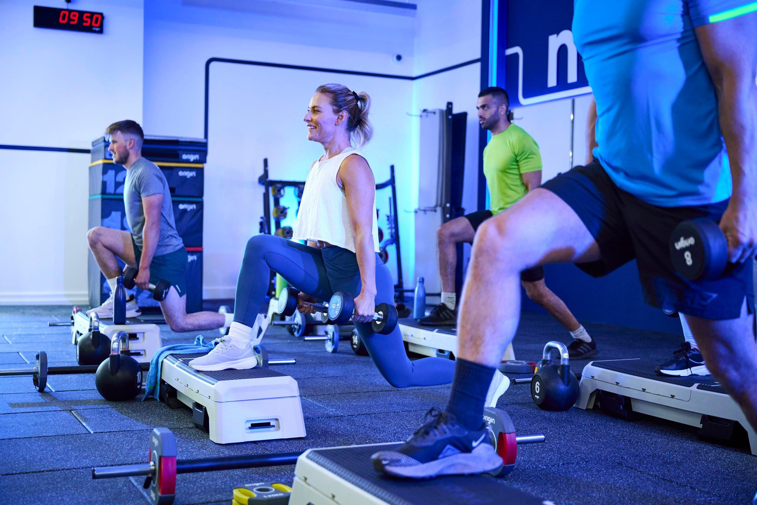 Gym members doing the isometric exercise: Static Lunge Hold.