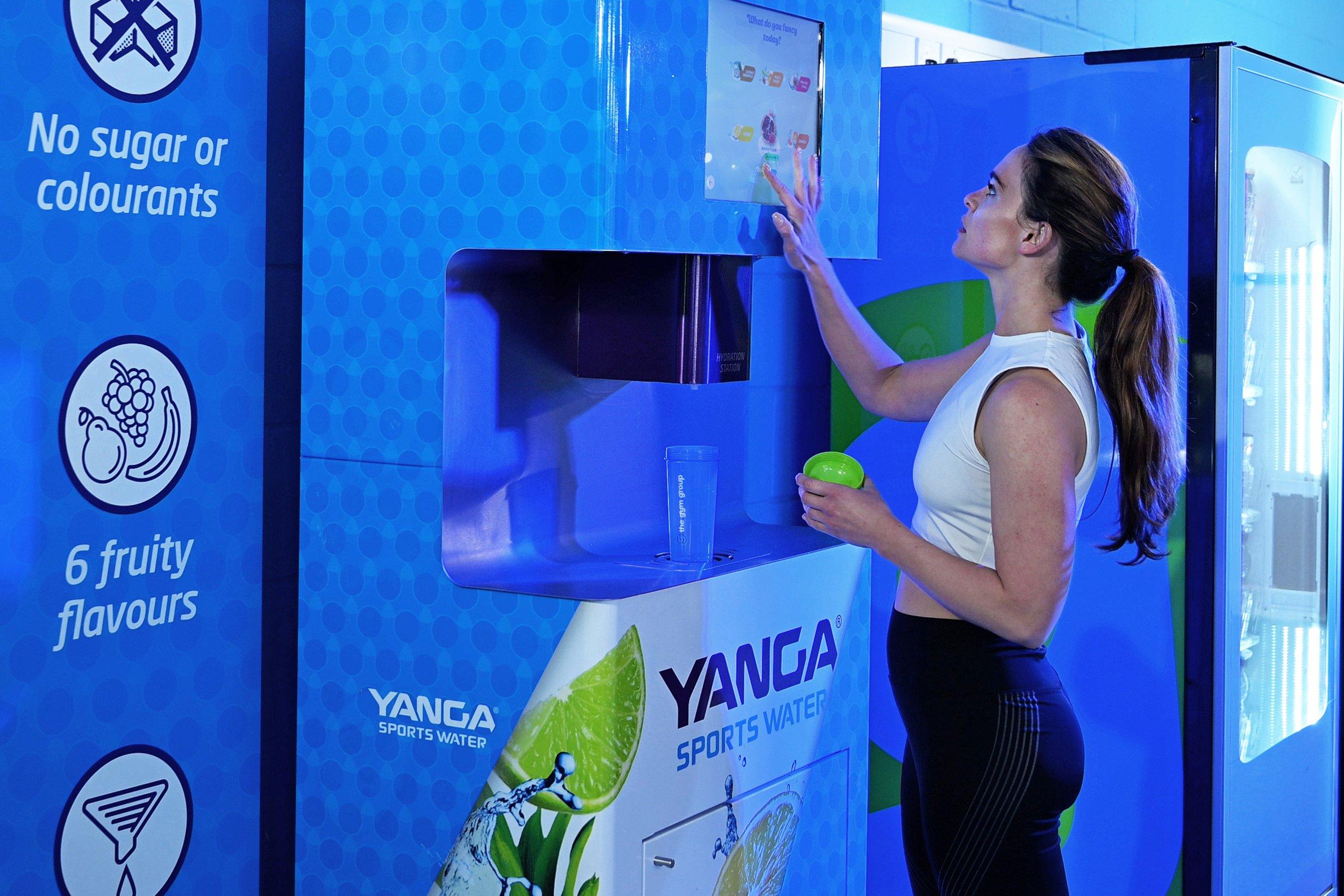 The Gym Group member selecting a drink flavour from the Yanga Sports Water machine.