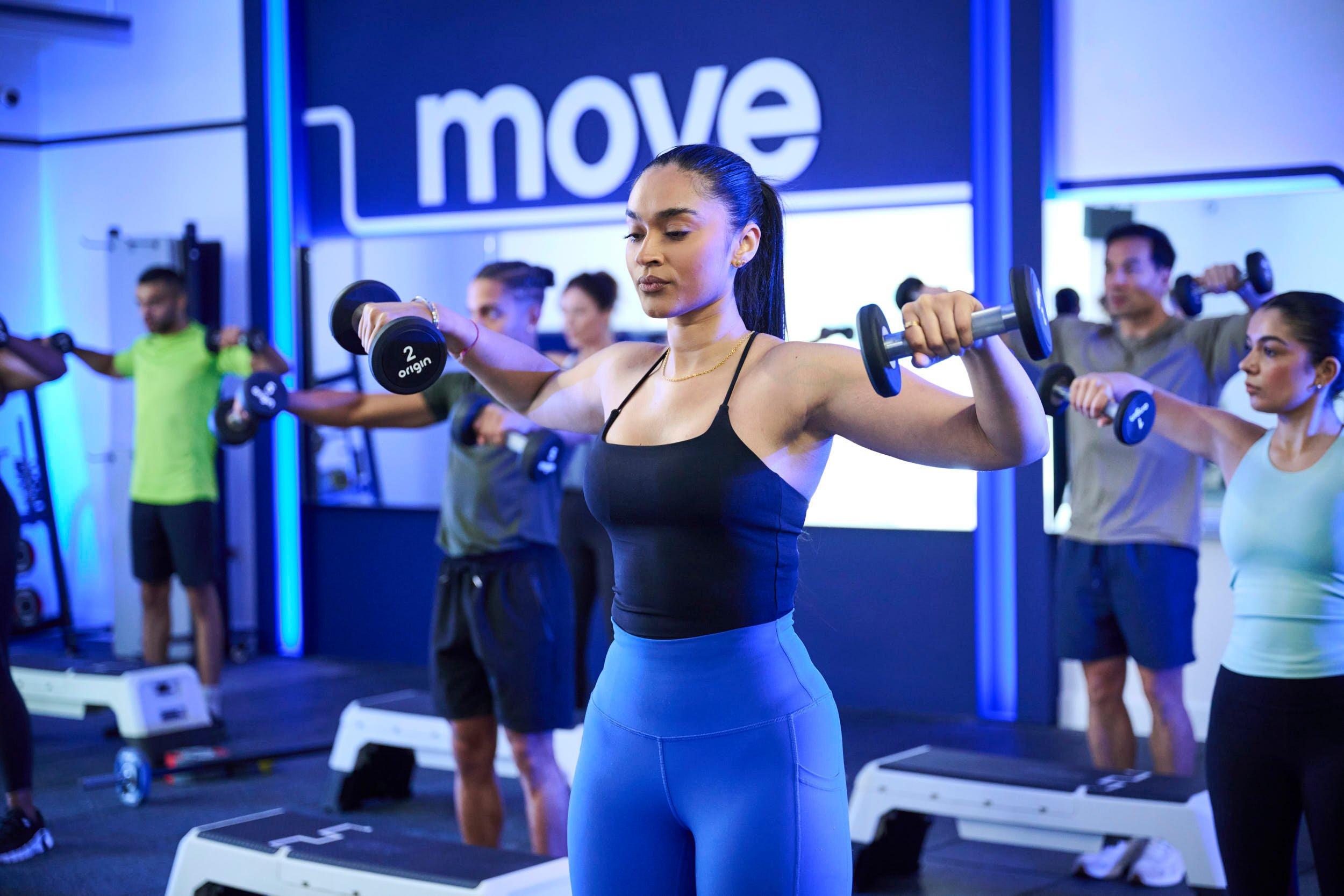 Members doing dumbbell back exercises at a gym clas