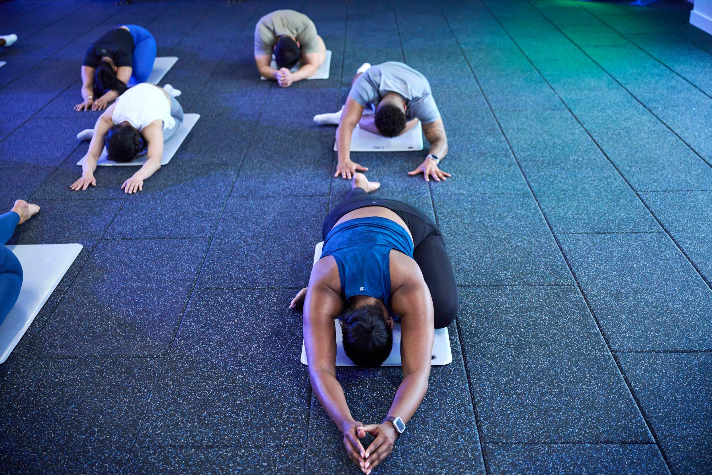 members doing the child pose at yoga pilates