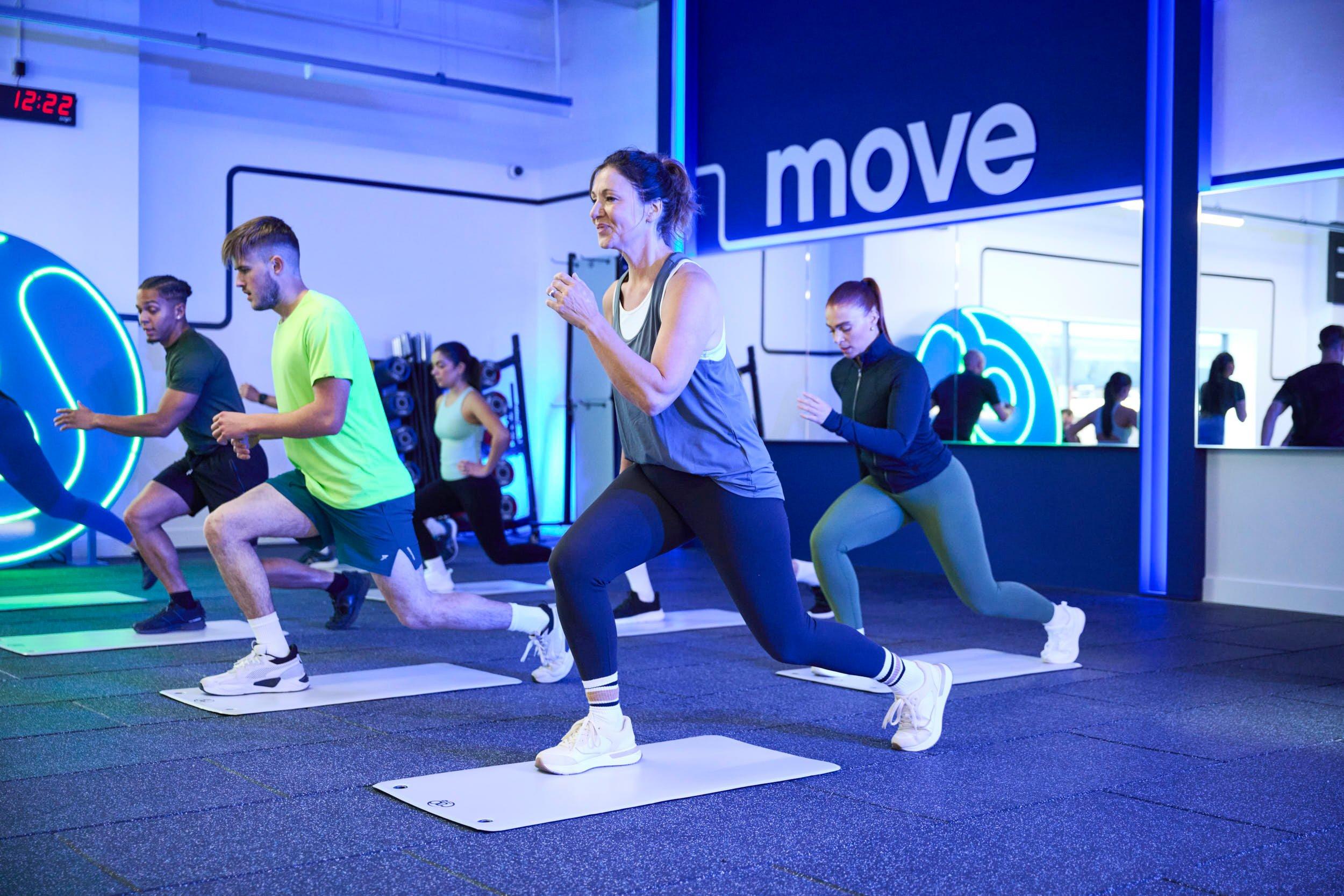 Members stretching at a gym cardio class