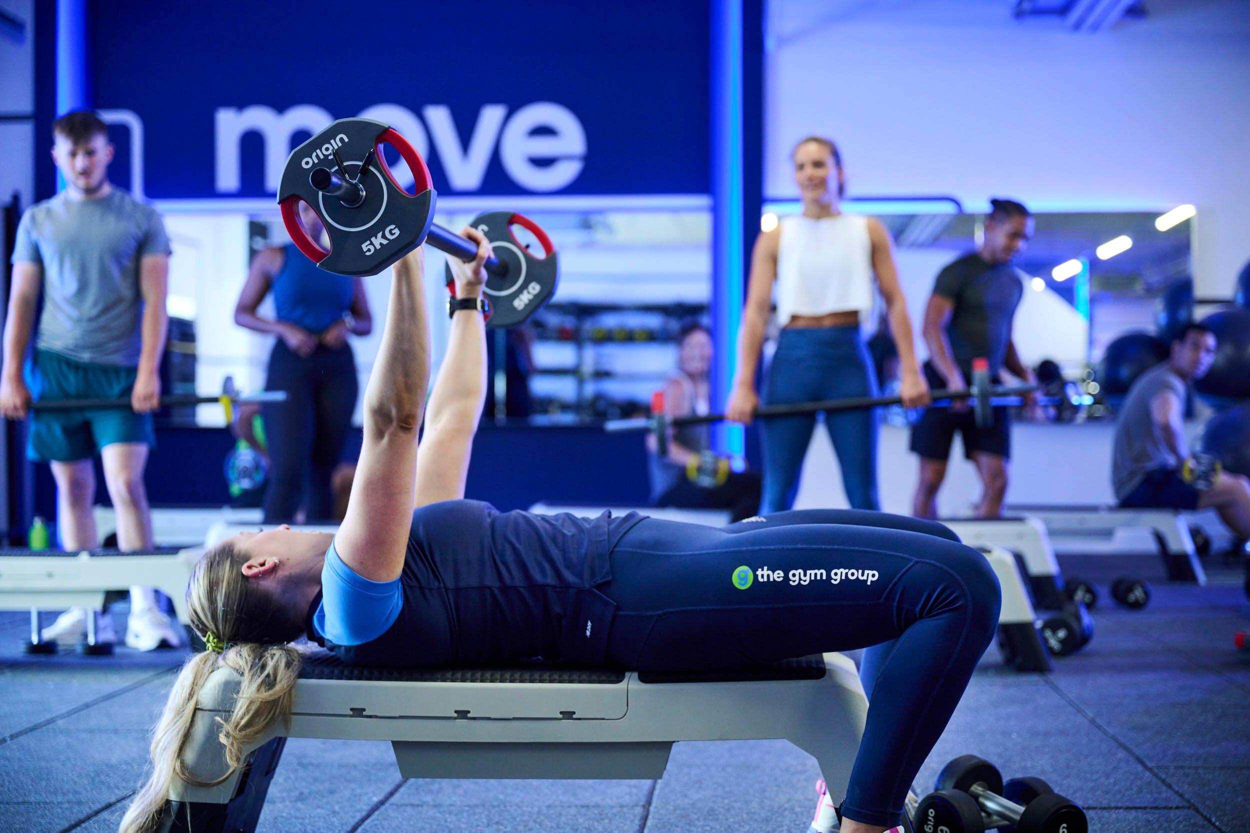 PT doing a bench press.