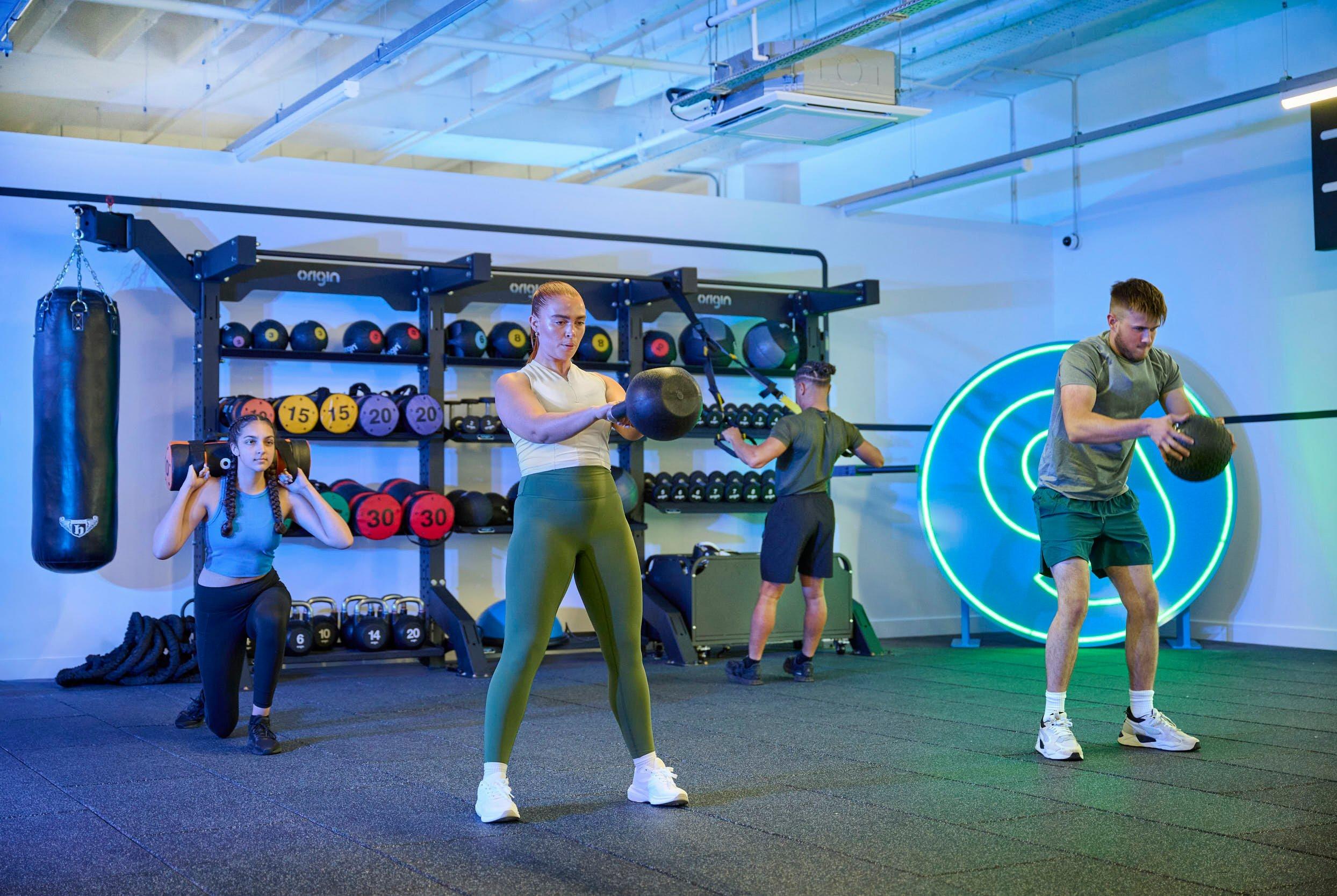 Female gym member doing kettlebell squats