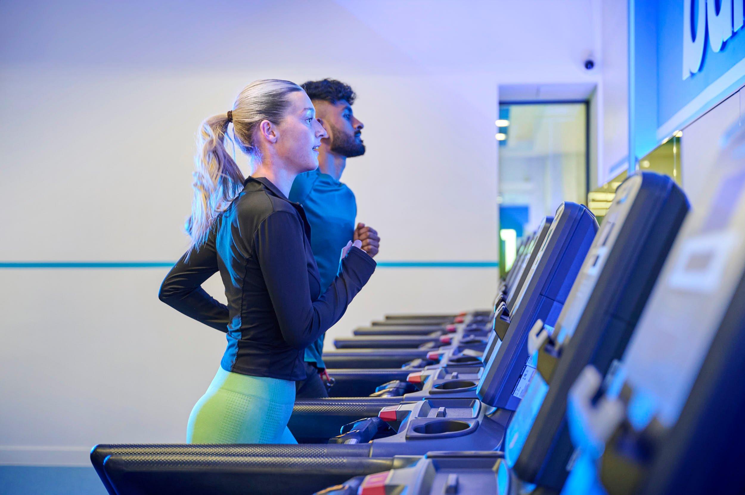 Personal trainer showing how to squat in a gym class