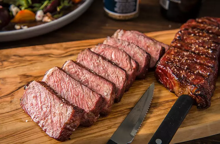 Grilling steaks shop on a traeger