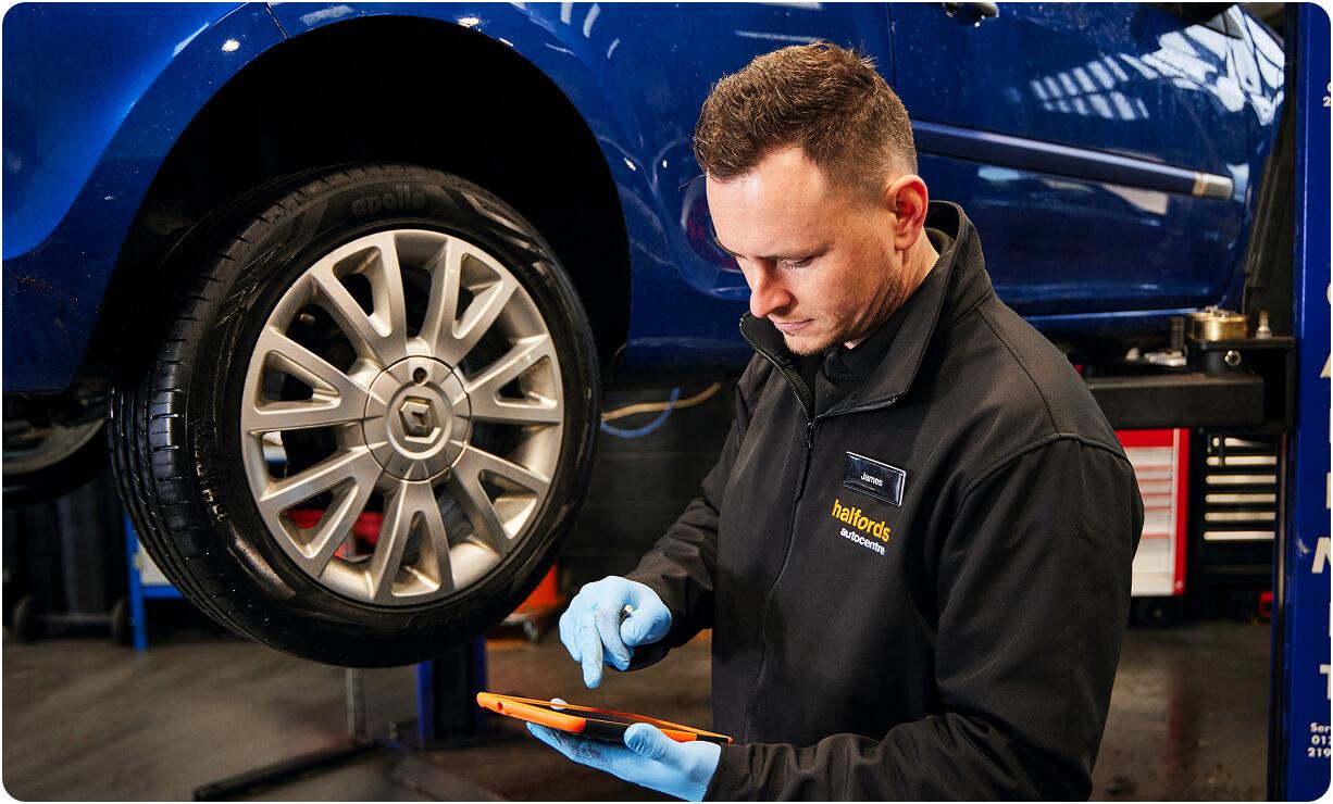 Technician checking a wheel as part of the manufacturer maintenance schedule