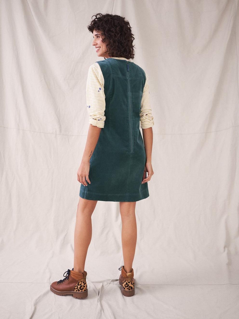 June Organic Pinny Dress in MID GREEN - MODEL BACK