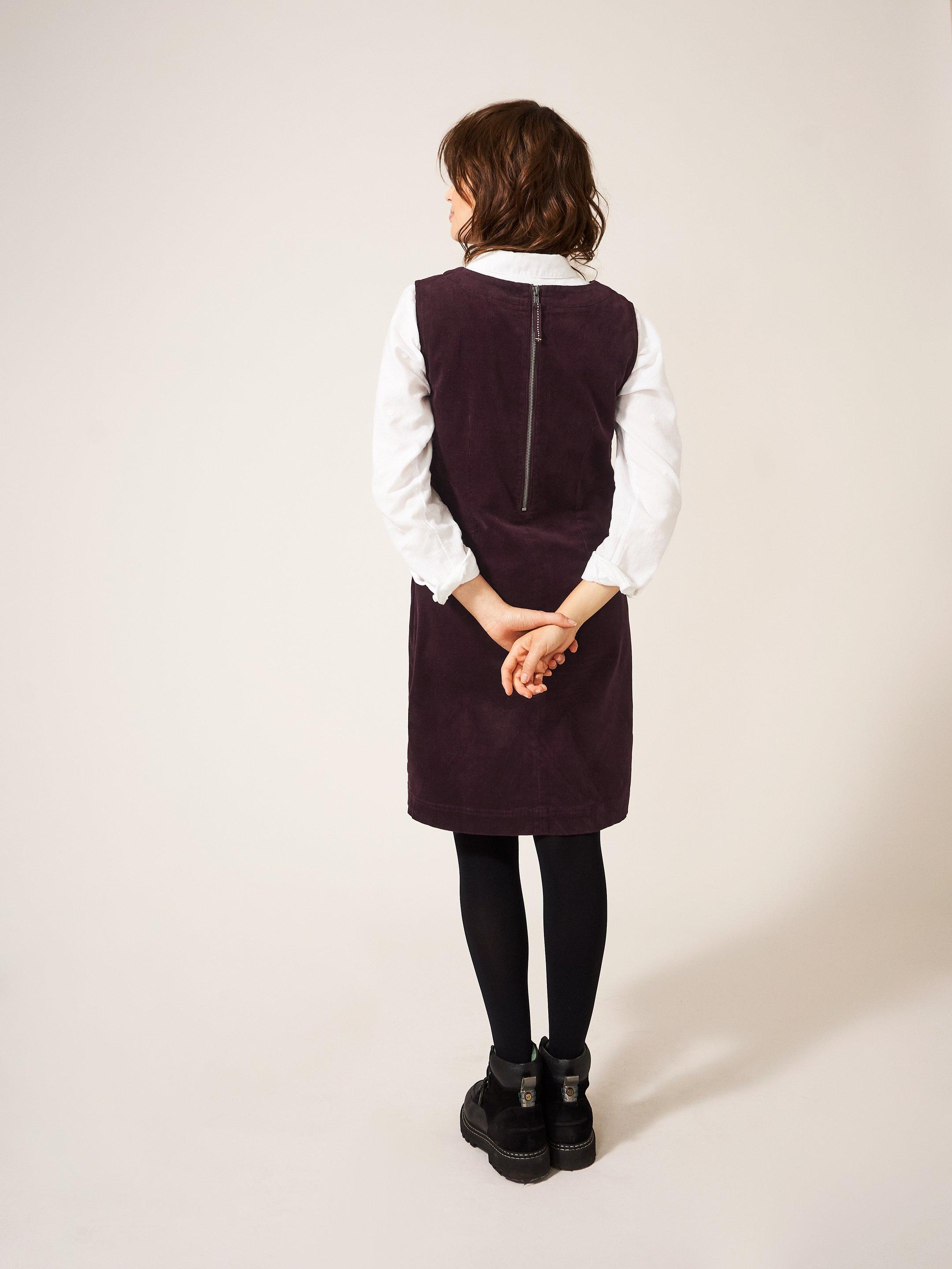 Lothbury Organic Cord Pinny in DK PLUM - MODEL BACK