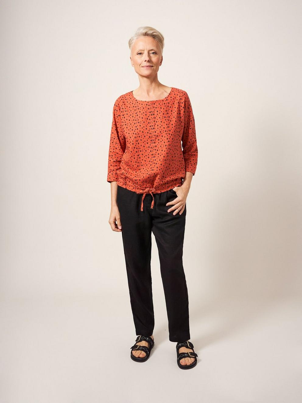 MADDIE MIX TOP in CORAL MLT - MODEL FRONT