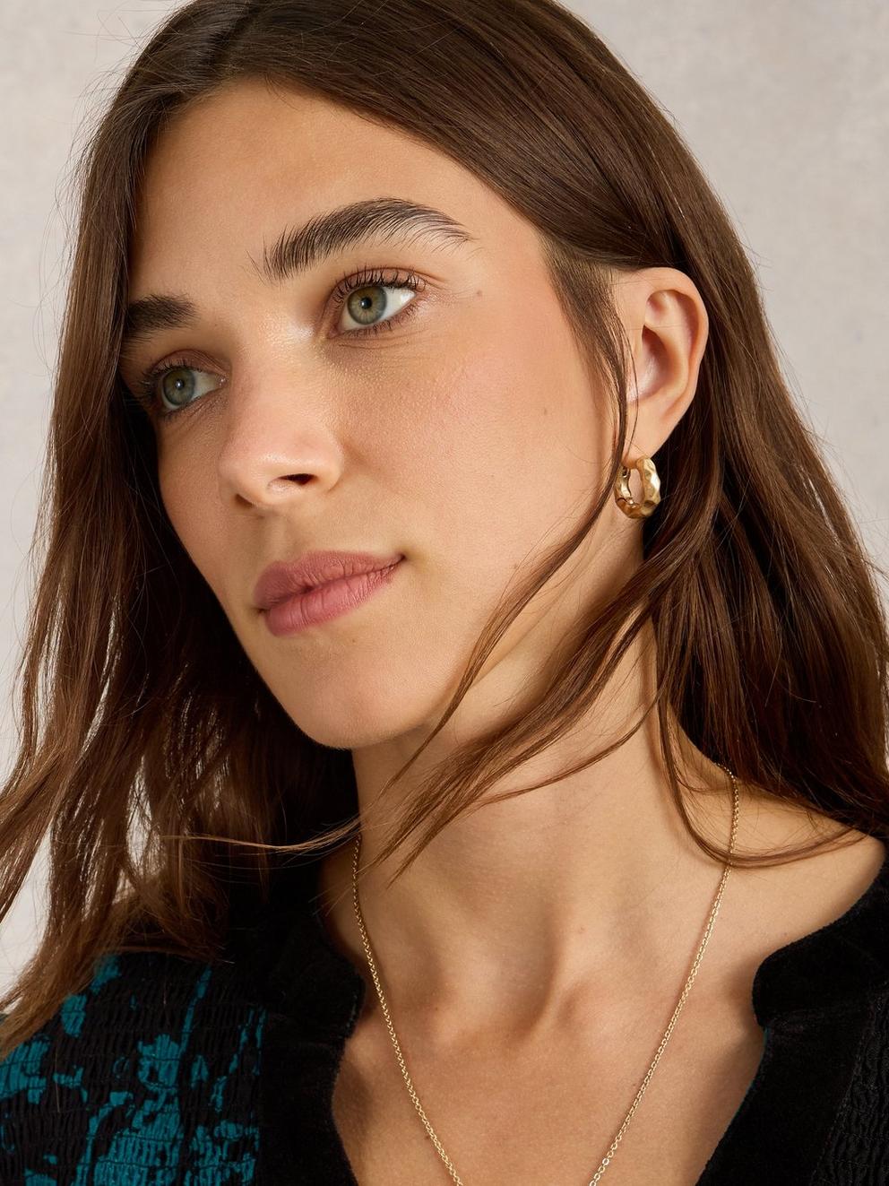 Berrie Huggie Earring in GLD TN MET - MODEL FRONT