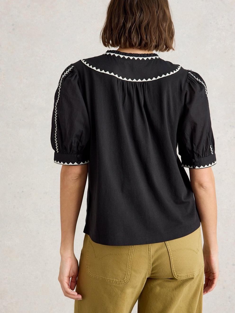 ZOE EMBROIDERED NOTCH NECK TOP in PURE BLK - MODEL BACK
