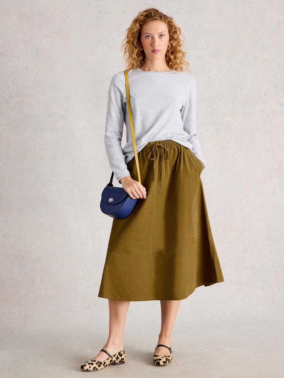 Tilly Cord Midi Skirt in KHAKI GRN - MODEL FRONT