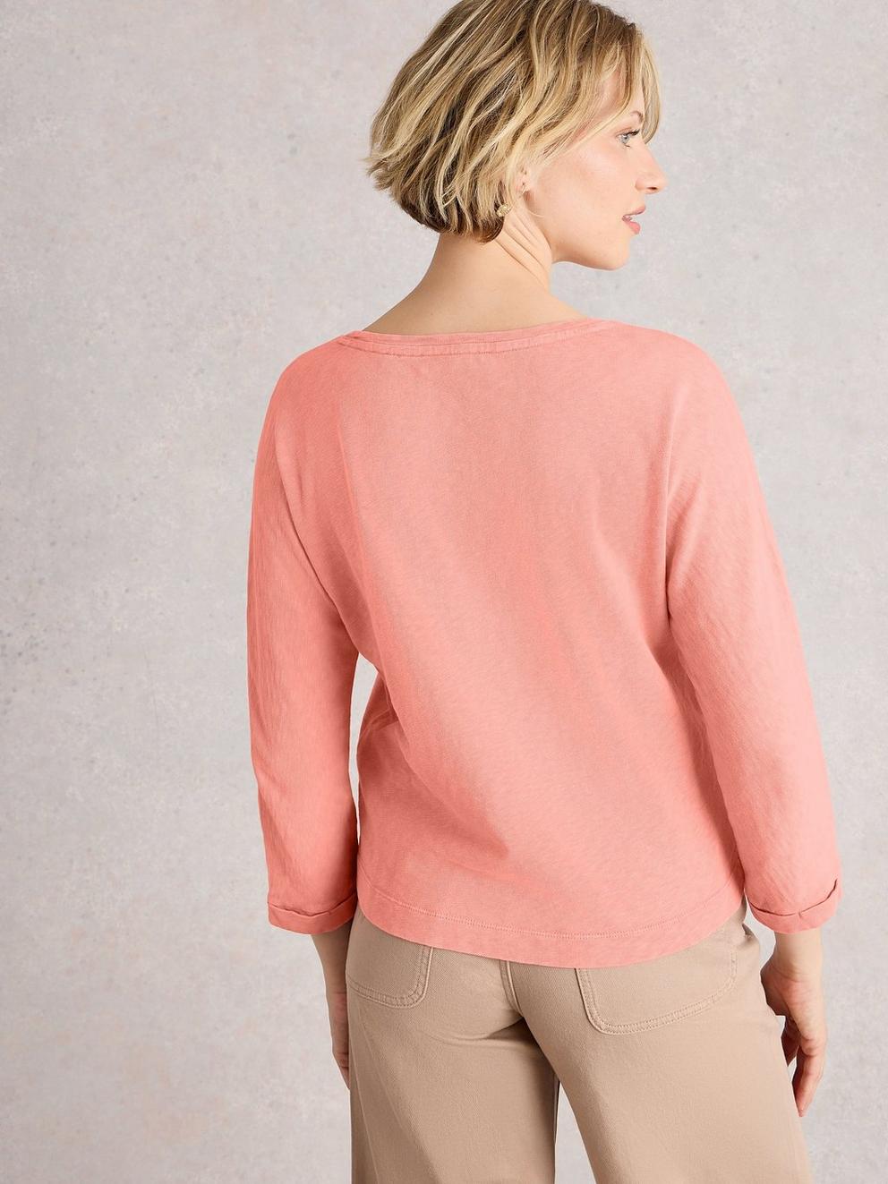DEMI DOLMAN CREW NECK TOP in MID CORAL - MODEL BACK