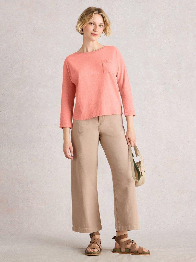 DEMI DOLMAN CREW NECK TOP in MID CORAL - MODEL FRONT