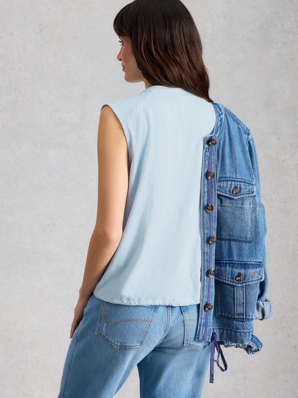 PEONY SLEEVELESS COLLARED SHIRT in MID BLUE - MODEL BACK