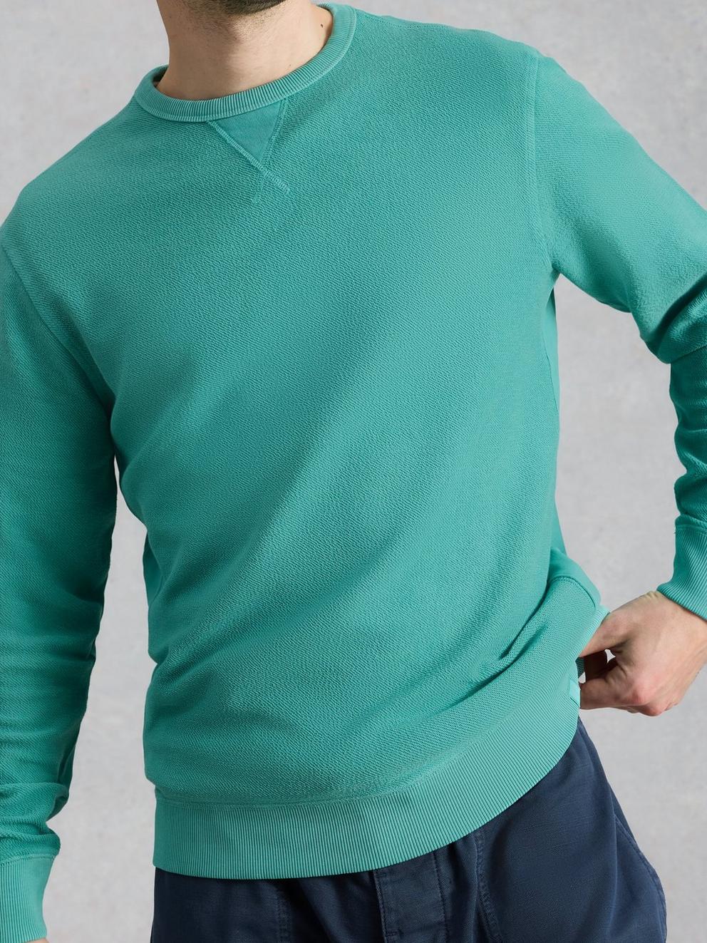 Sidmouth Crew Neck Jumper in MID GREEN - MODEL DETAIL