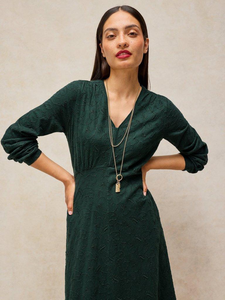 MEGAN EMBROIDERED JERSEY DRESS in DK GREEN - MODEL FRONT