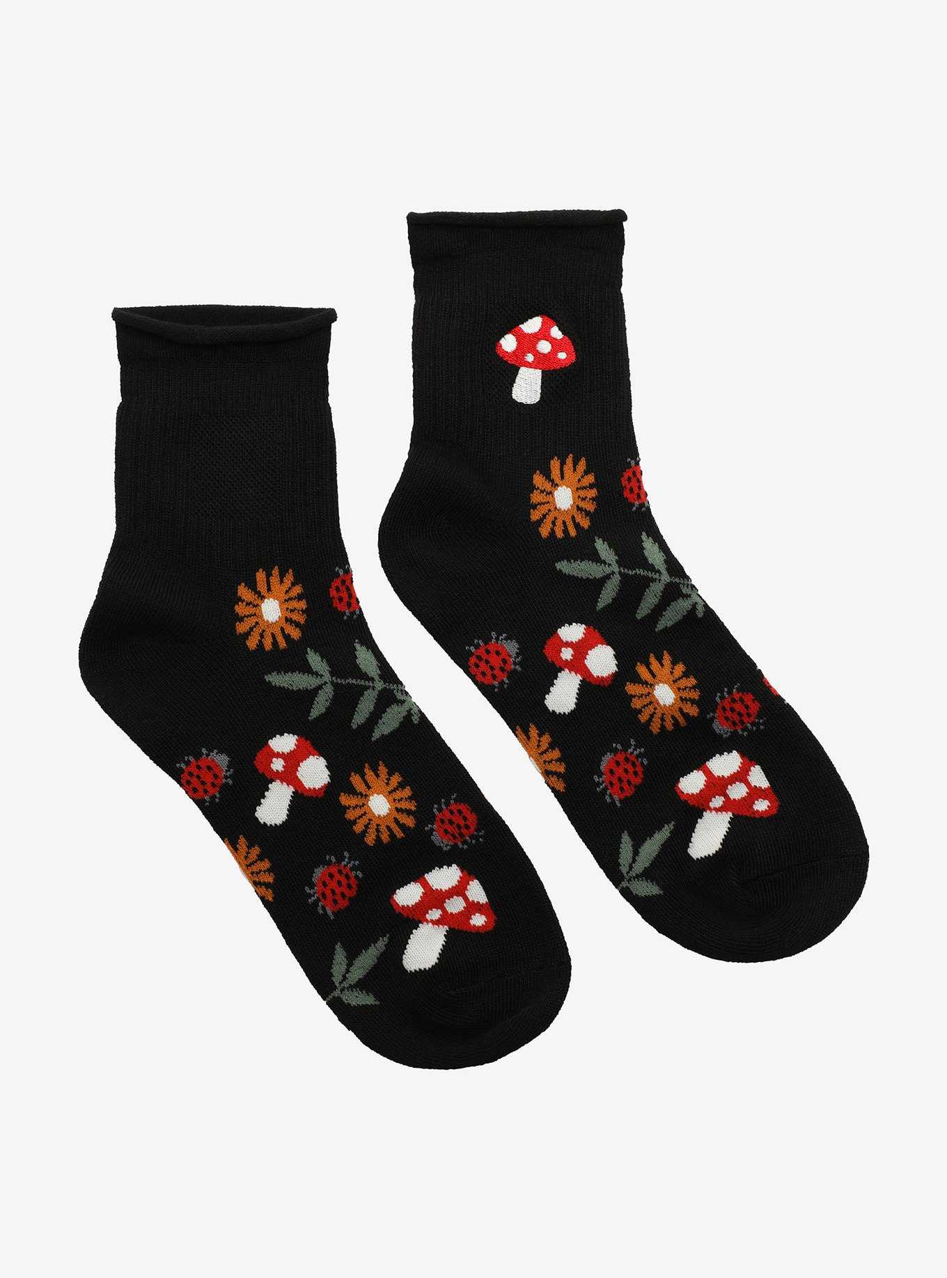 Cropped view of beautiful female legs in dark green ankle socks with red  hearts. The young